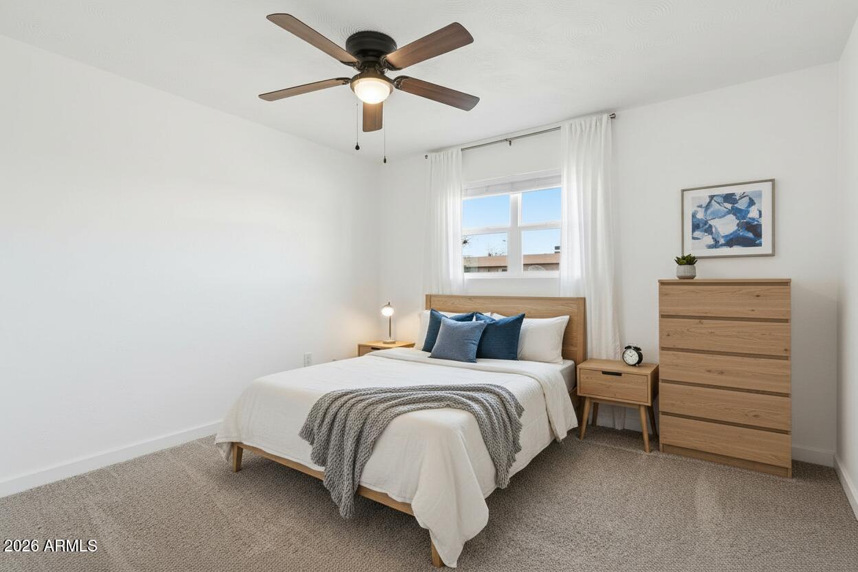 1052 West Elna Rae Street Tempe, AZ 85281 - Photo 12 of 16 a bedroom with a bed and a chandelier