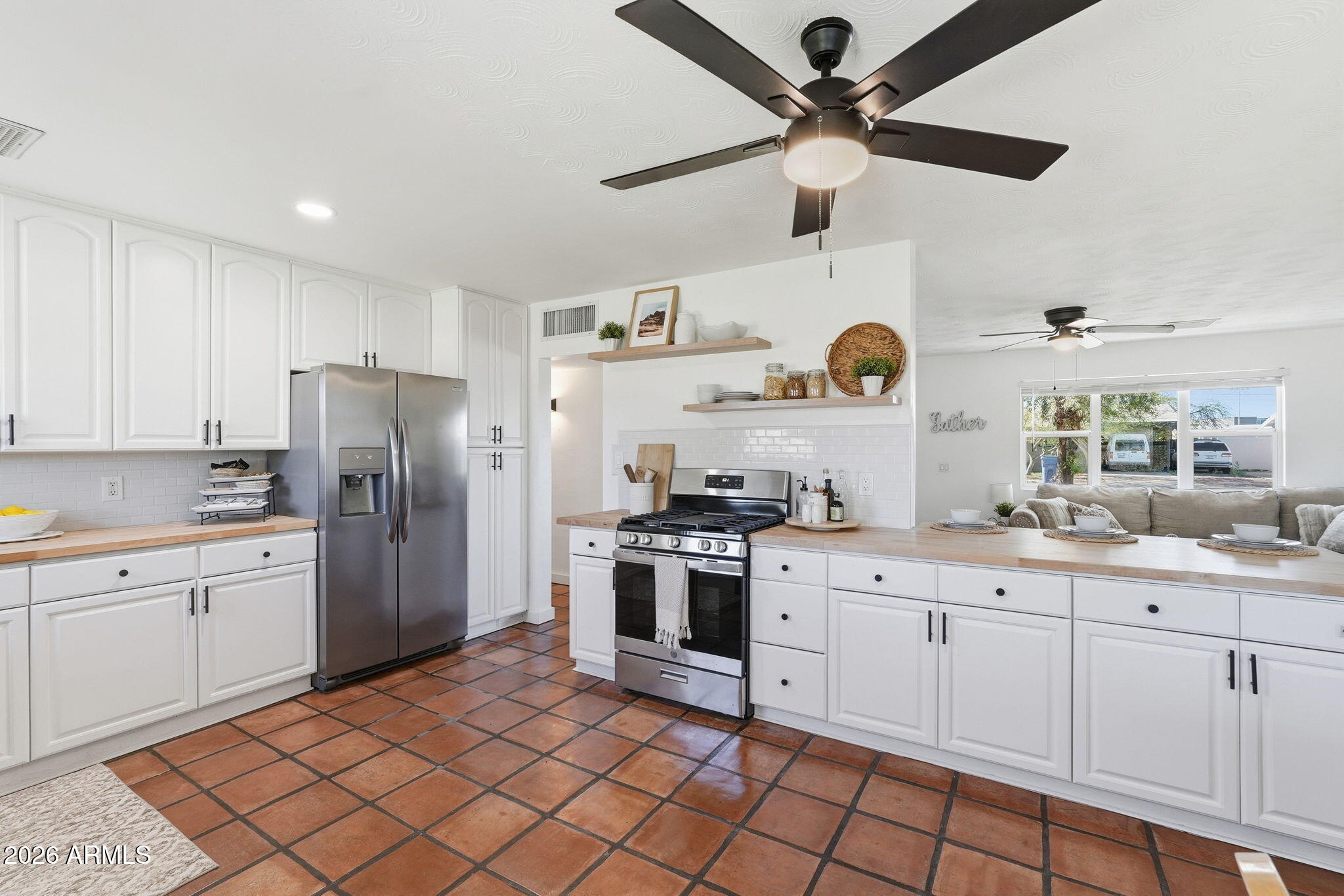 1052 West Elna Rae Street Tempe, AZ 85281 - Photo 3 of 16 a kitchen with stainless steel appliances granite countertop a sink and cabinets
