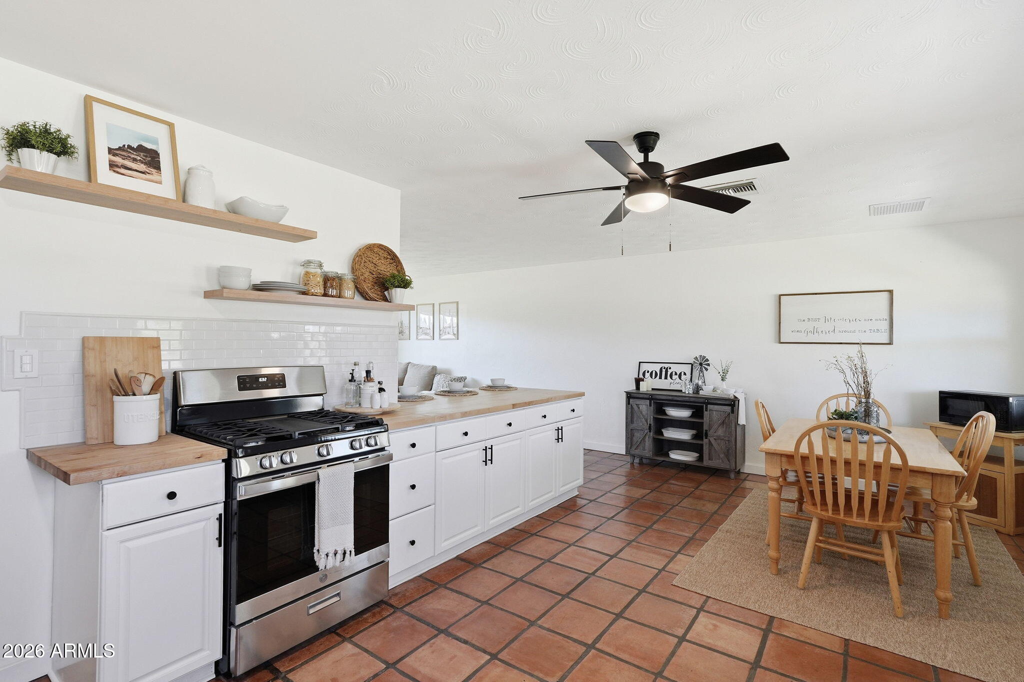 1052 West Elna Rae Street Tempe, AZ 85281 - Photo 4 of 16 a kitchen with stainless steel appliances granite countertop a stove a chimney a sink and a refrigerator