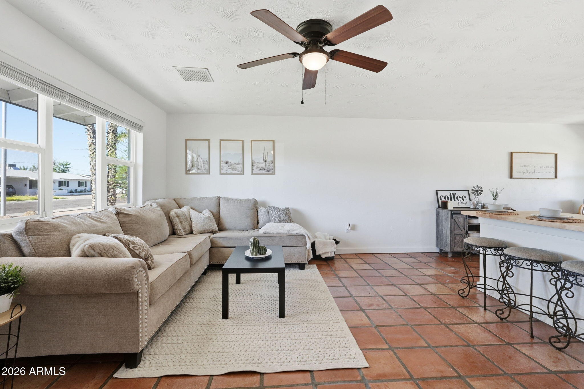 1052 West Elna Rae Street Tempe, AZ 85281 - Photo 6 of 16 a living room with furniture a rug and a chandelier
