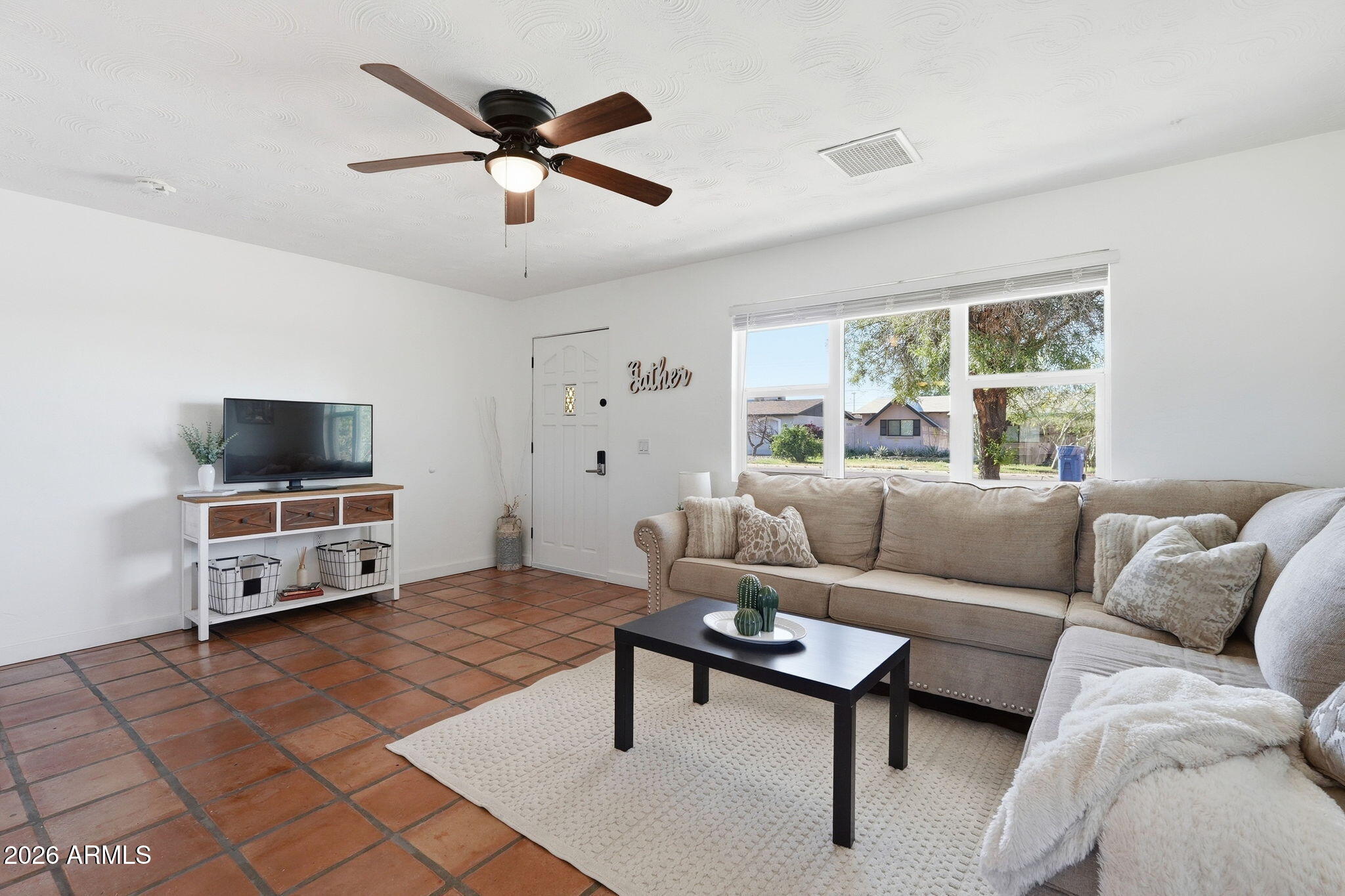 1052 West Elna Rae Street Tempe, AZ 85281 - Photo 7 of 16 a living room with furniture and a flat screen tv