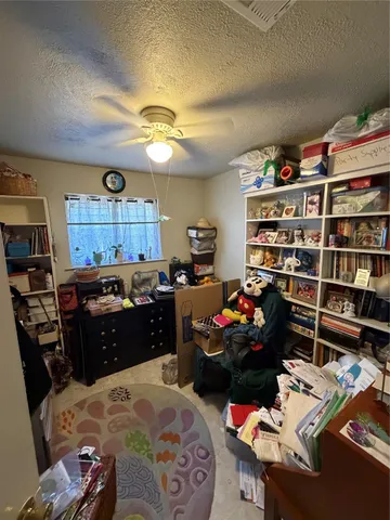 a bed room with a bed window and book shelf