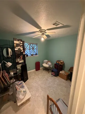 a room with furniture and a ceiling fan