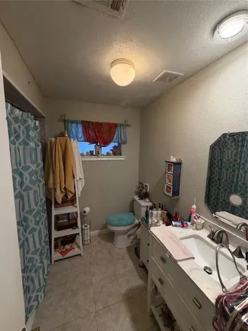 a bathroom with a sink a toilet and a shower