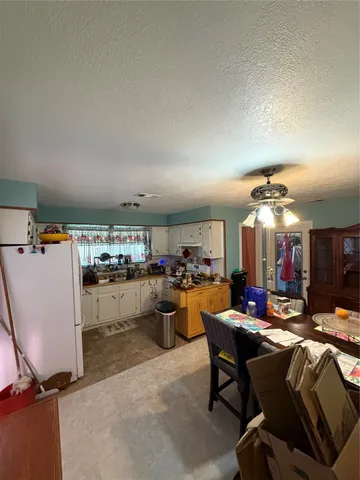 a view of a dining room with furniture and a chandelier