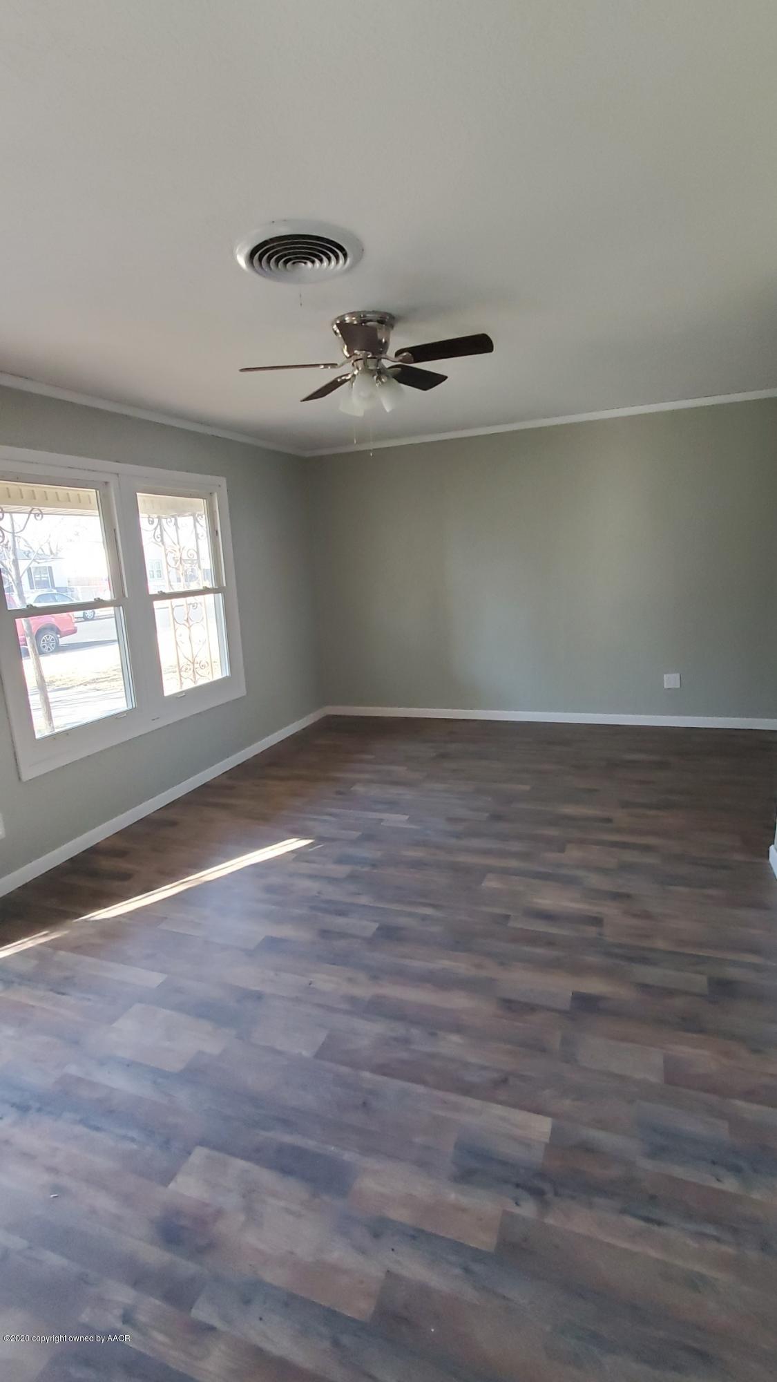 3809 South Jackson Street Amarillo, TX 79110 - Photo 6 of 17 an empty room with wooden floor and windows