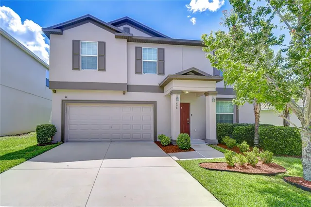 a front view of a house with a yard and garage