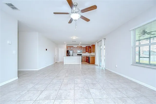a view of a livingroom with a ceiling fan and window