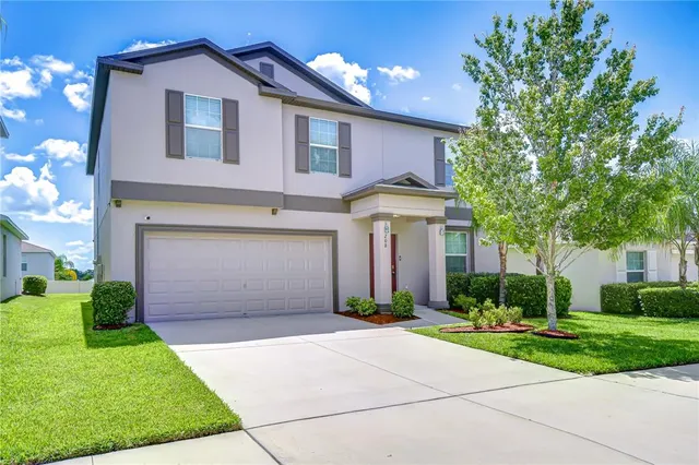 a front view of house with yard and green space