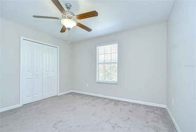 a bathroom with a granite countertop sink toilet a mirror and shower