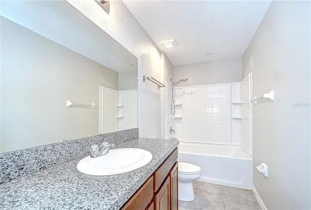 an empty room with a window and a ceiling fan