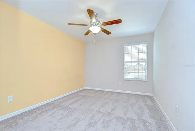 an empty room with closet and windows