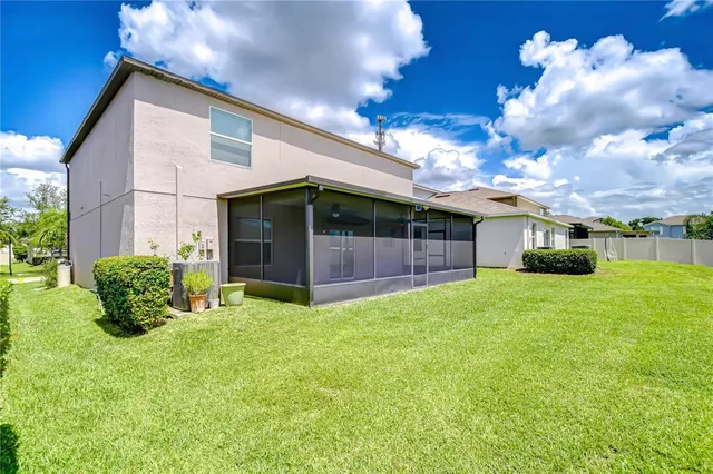 a view of a house with backyard and garden