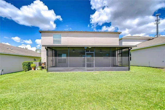 a view of a house with a yard and sitting area