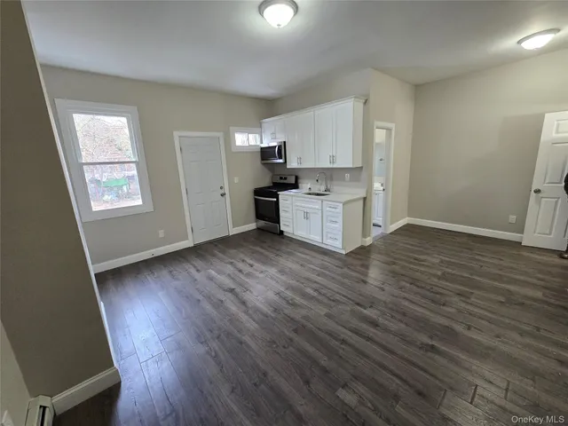a view of a room with wooden floor and sink