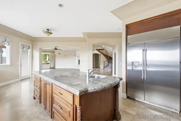 a view of a room with wooden floor a ceiling fan and window
