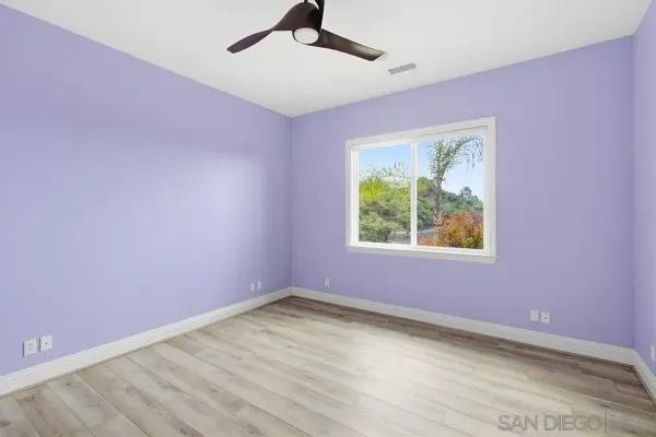 a bathroom with a granite countertop sink toilet a mirror and shower