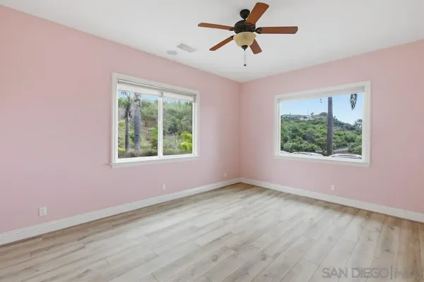 a bathroom with a granite countertop sink a mirror and shower