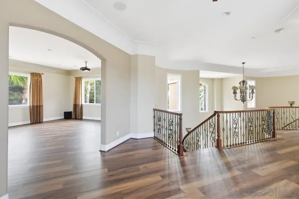 a view of room with window and wooden floor