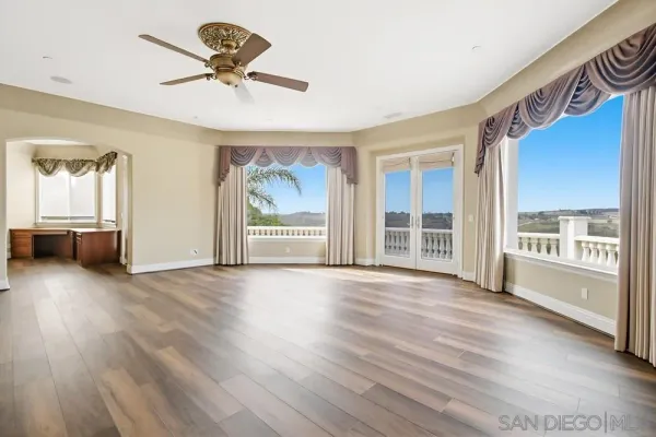 a view of a kitchen with a window and wooden floor