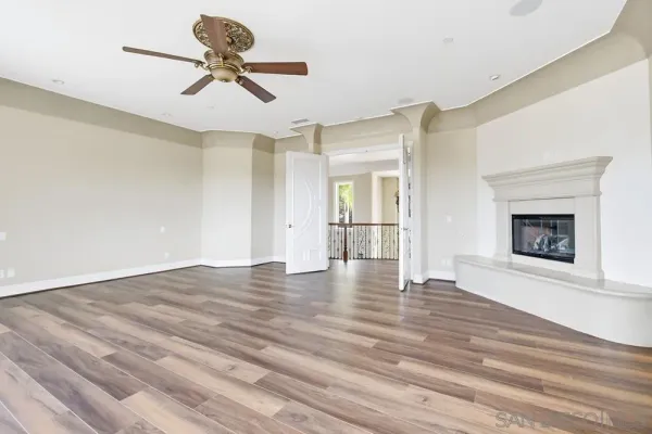 a spacious bathroom with a granite countertop double vanity sink a mirror and a