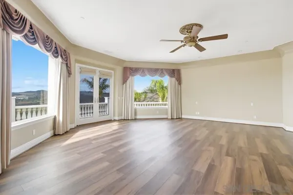 a bathroom with a granite countertop sink mirror and window