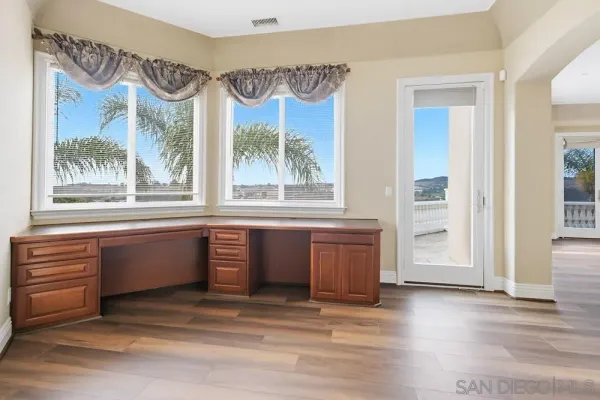a kitchen with a refrigerator and cabinets