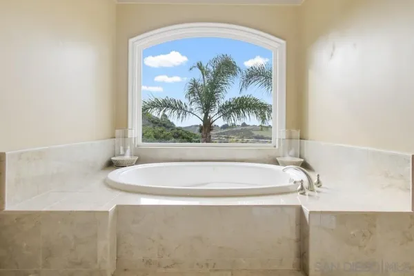a view of a patio with a table and chairs under an umbrella
