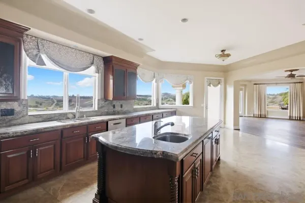 a kitchen with stainless steel appliances granite countertop a stove and a refrigerator