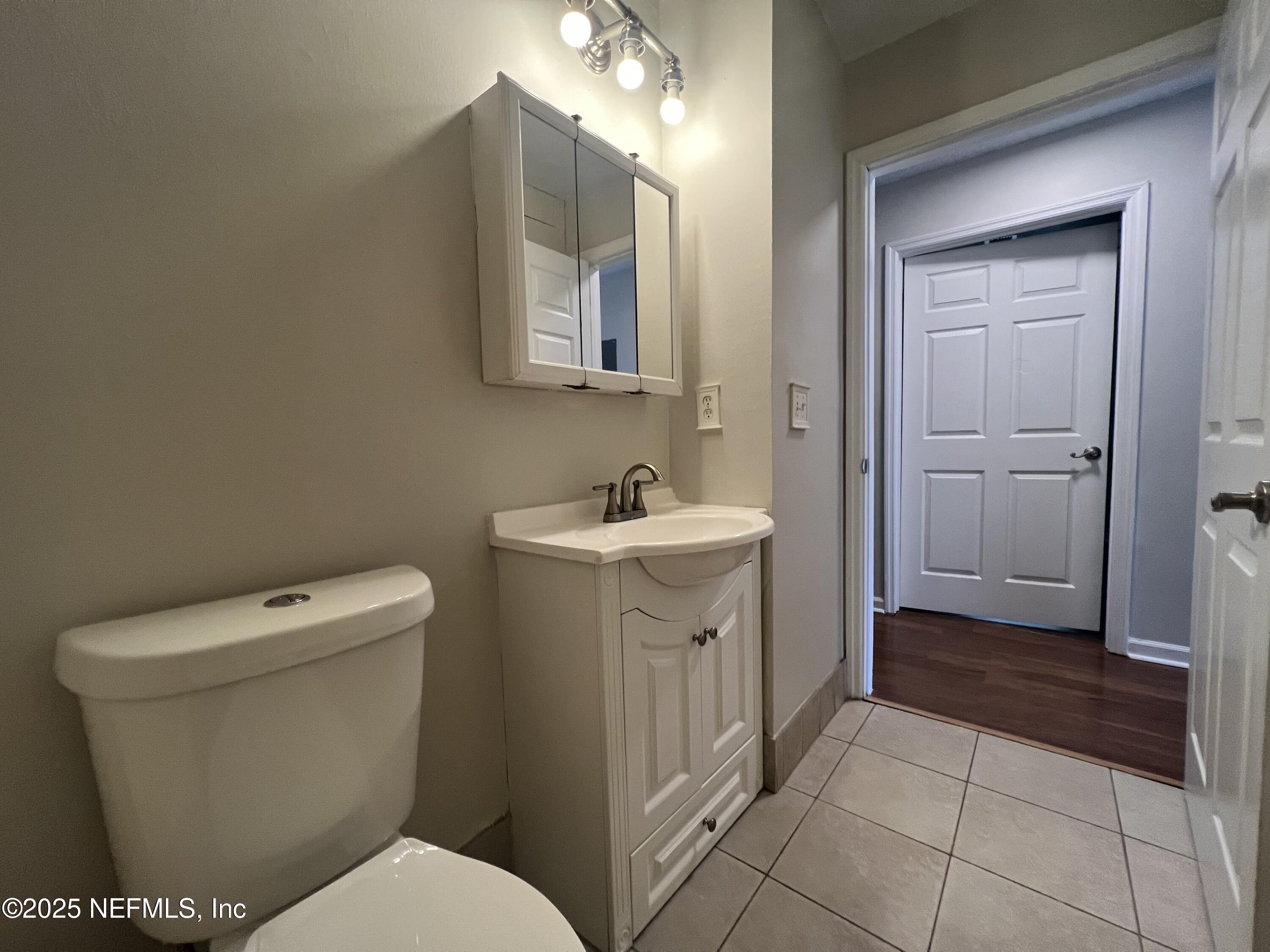 1508 Center Street Green Cove Springs, FL 32043 - Photo 11 of 24 a bathroom with a toilet sink and mirror