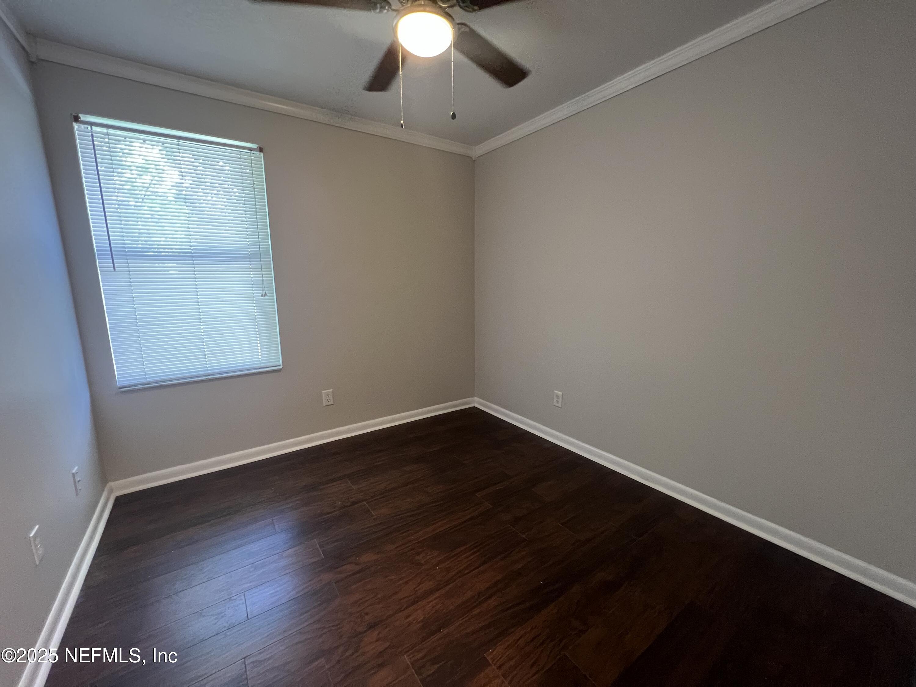 1508 Center Street Green Cove Springs, FL 32043 - Photo 12 of 24 an empty room with wooden floor and windows