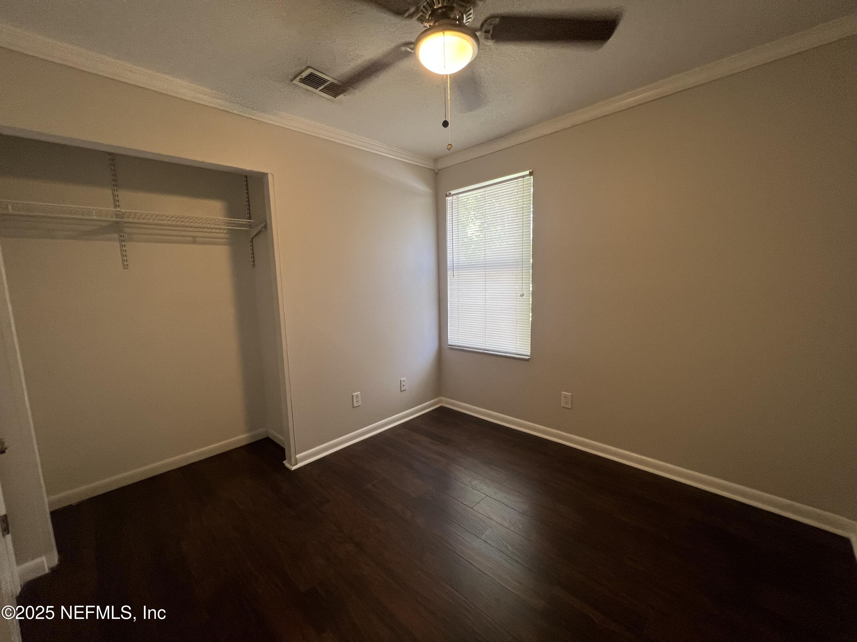 1508 Center Street Green Cove Springs, FL 32043 - Photo 13 of 24 a view of an empty room with wooden floor and a window