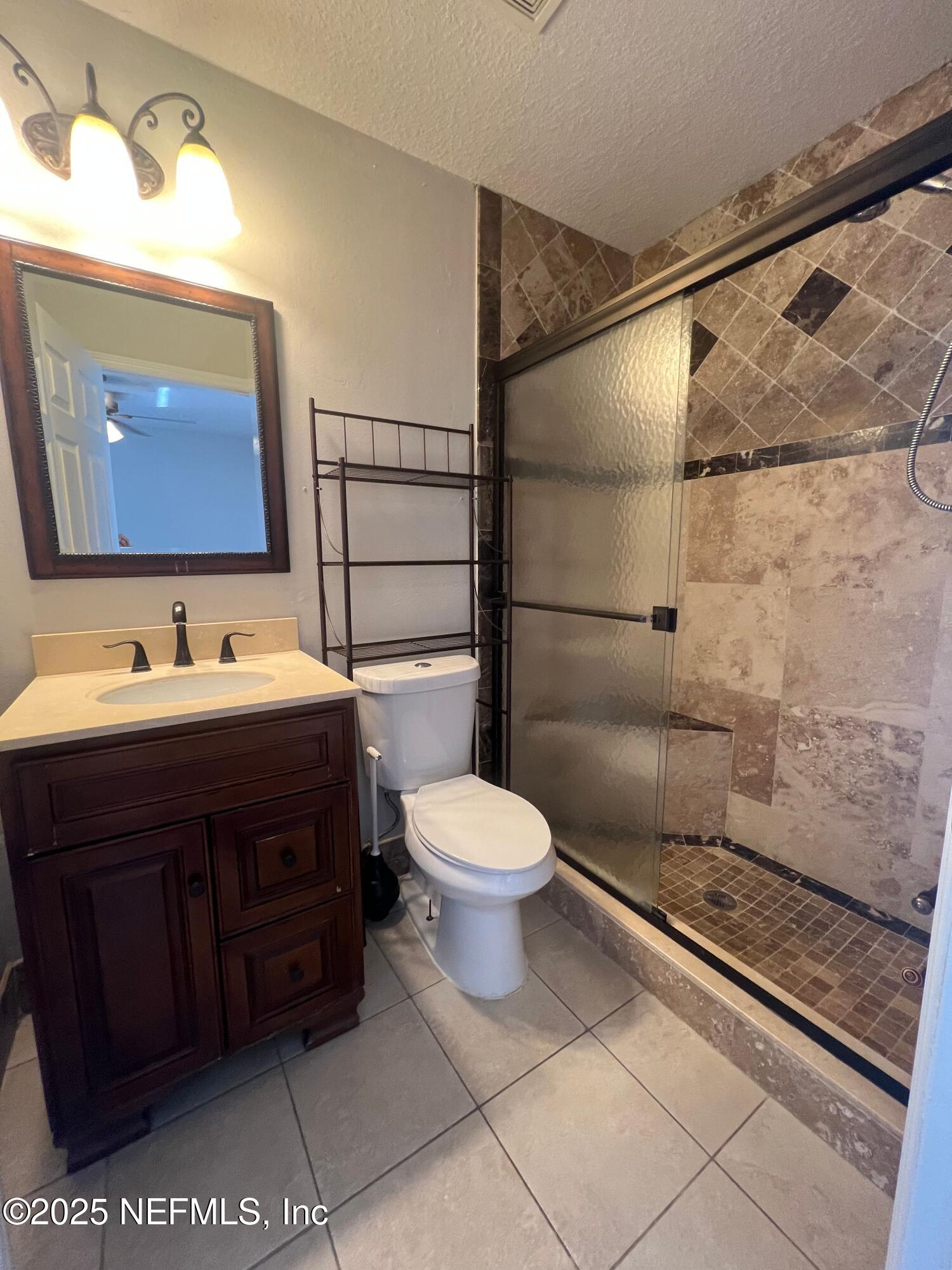 1508 Center Street Green Cove Springs, FL 32043 - Photo 15 of 24 a bathroom with a toilet sink and mirror