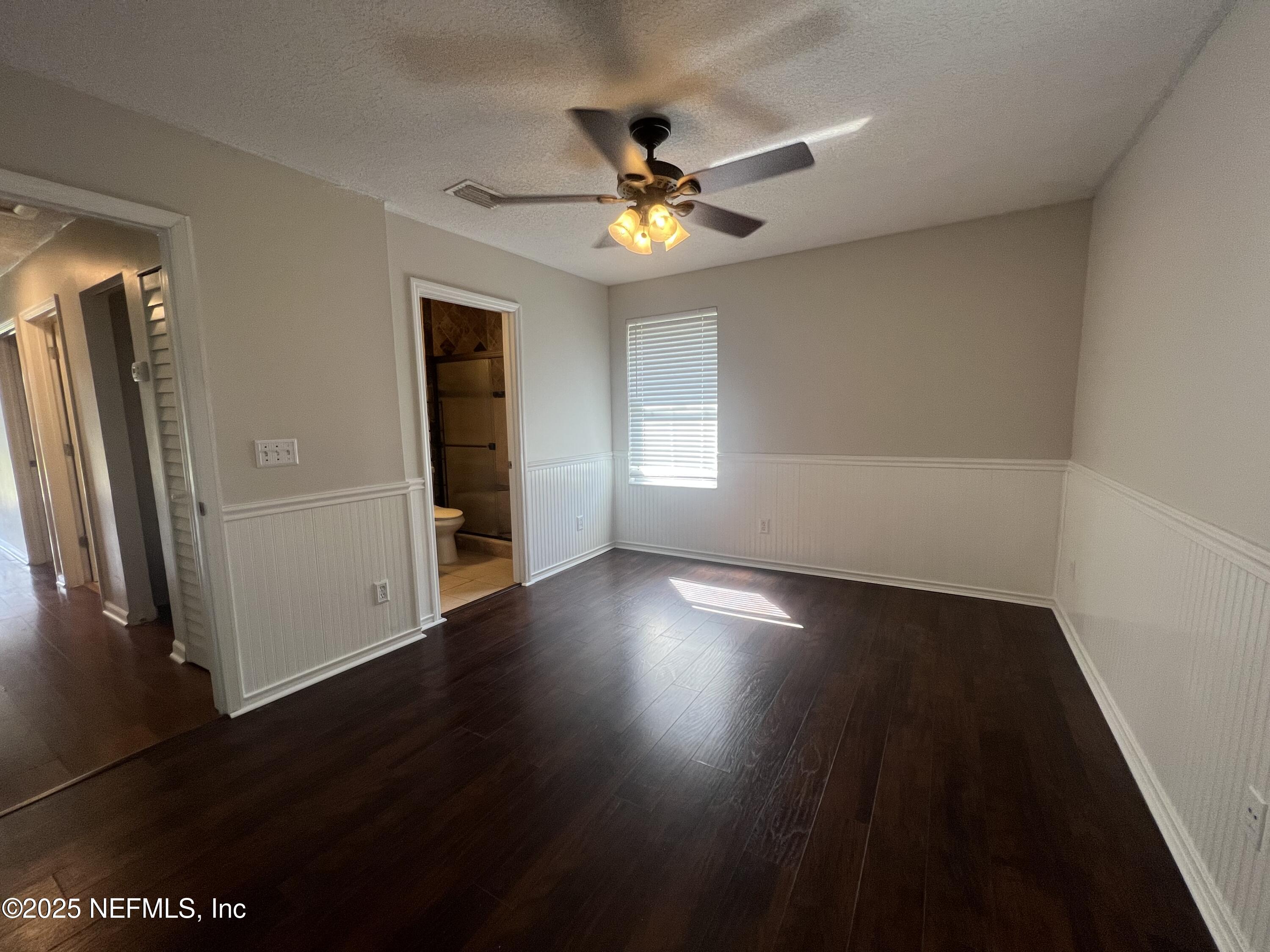 1508 Center Street Green Cove Springs, FL 32043 - Photo 17 of 24 an empty room with wooden floor a ceiling fan and windows