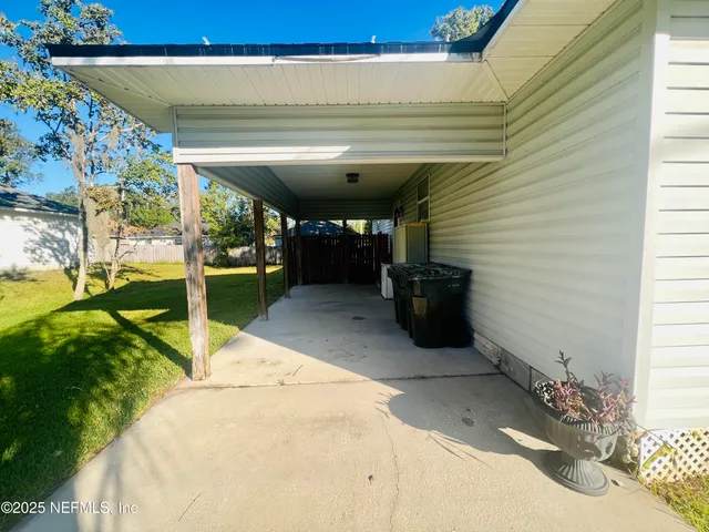 a kitchen with granite countertop stainless steel appliances cabinets a sink and a large window
