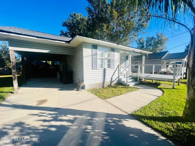 a kitchen with granite countertop a refrigerator stove and cabinets