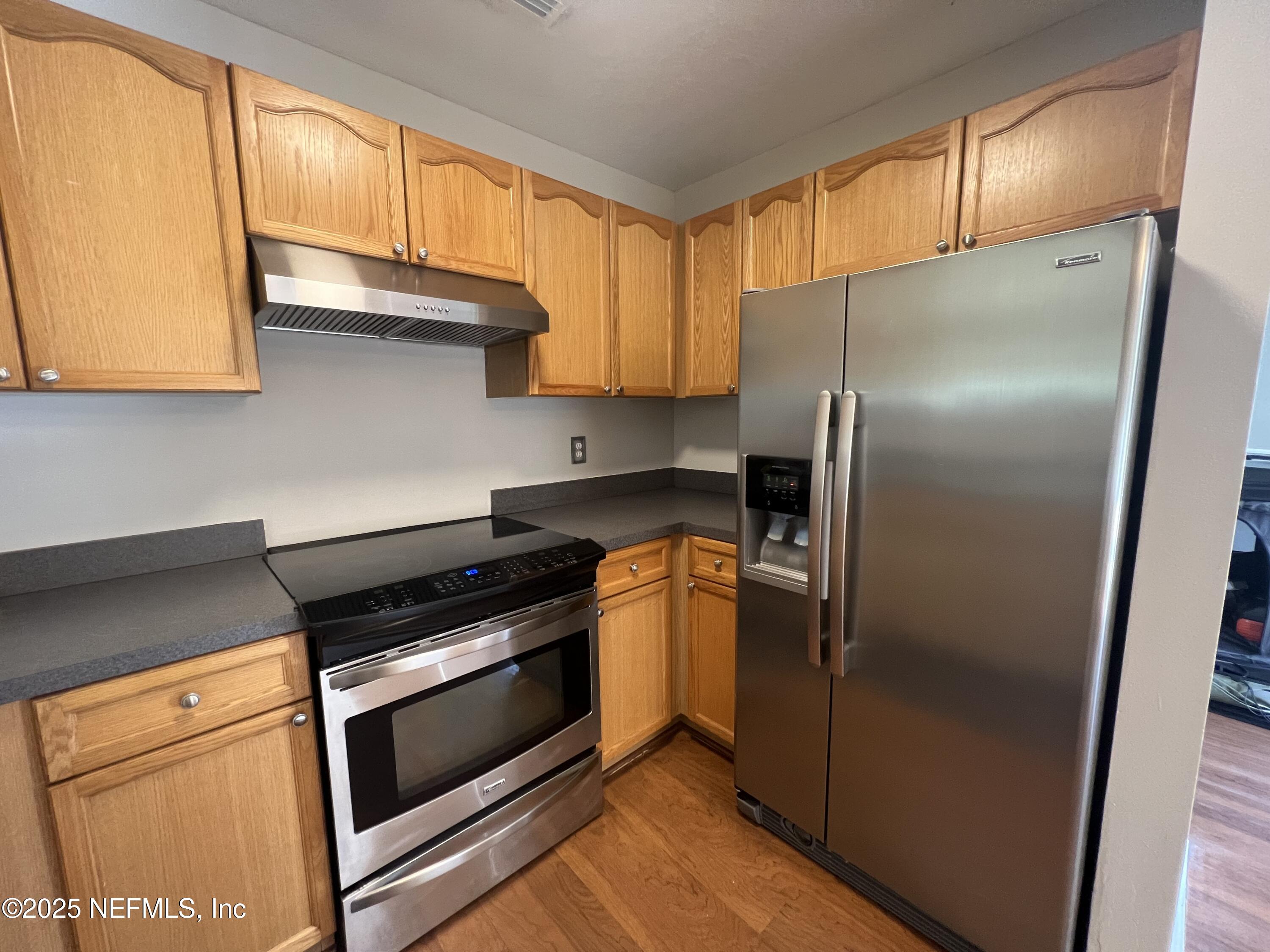 1508 Center Street Green Cove Springs, FL 32043 - Photo 7 of 24 a kitchen with granite countertop a refrigerator stove and cabinets