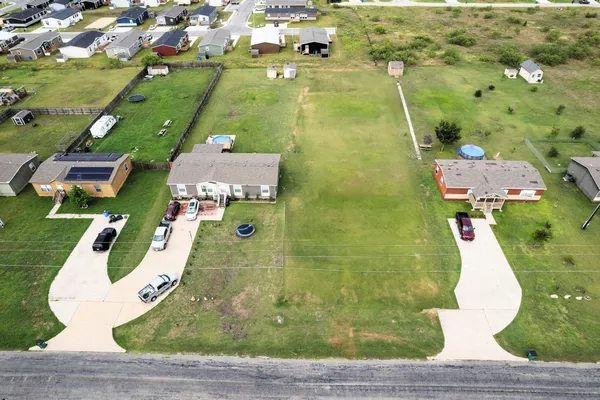 an aerial view of residential houses with outdoor space