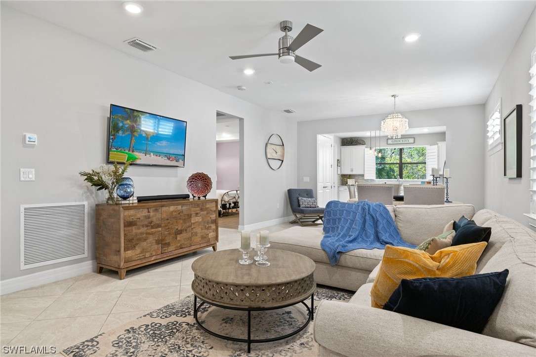 11237 Carlingford Road Fort Myers, FL 33913 - Photo 14 of 38 a living room with furniture a window and a chandelier