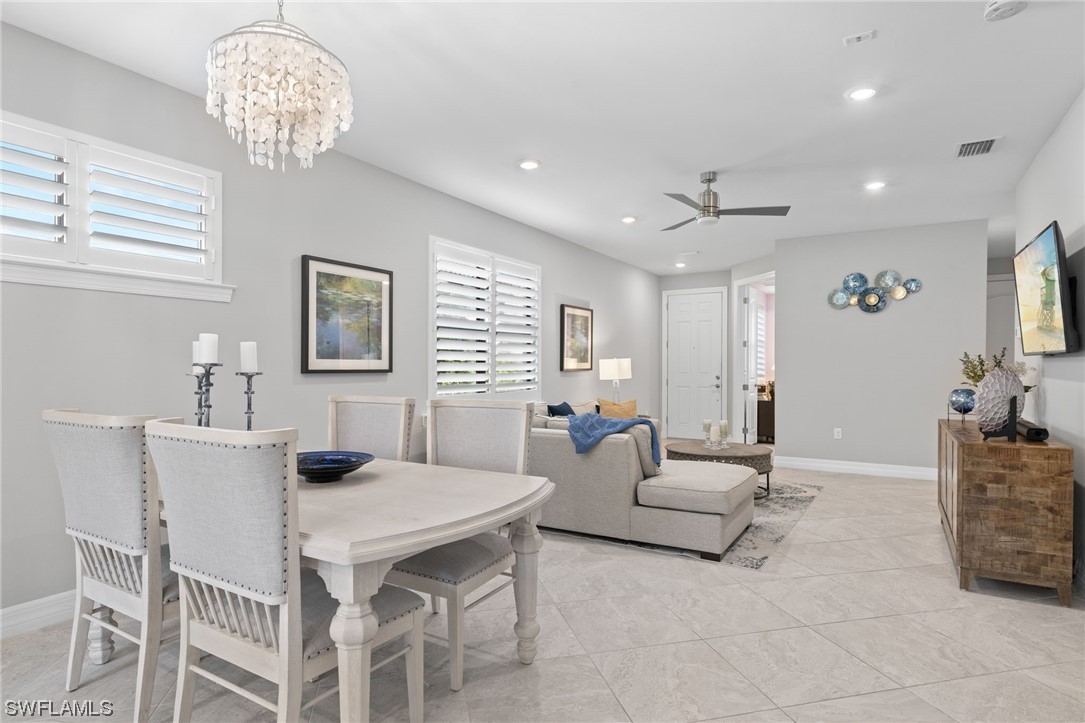 11237 Carlingford Road Fort Myers, FL 33913 - Photo 15 of 38 a living room with furniture a table and a chandelier