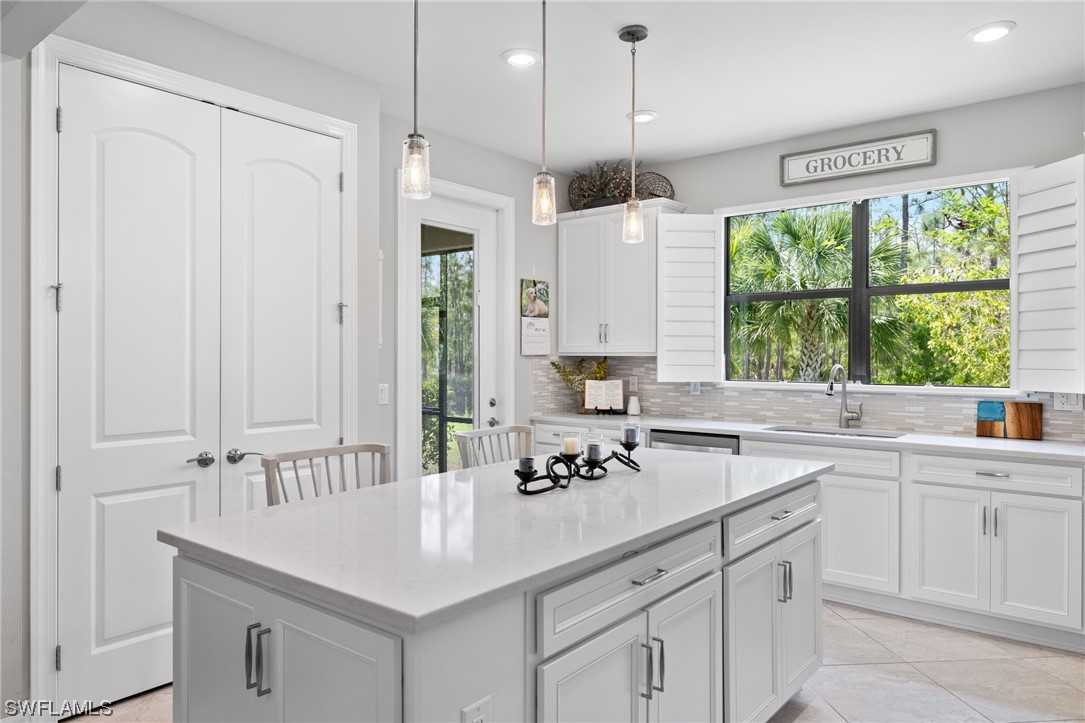 11237 Carlingford Road Fort Myers, FL 33913 - Photo 18 of 38 a kitchen with a sink window and cabinets