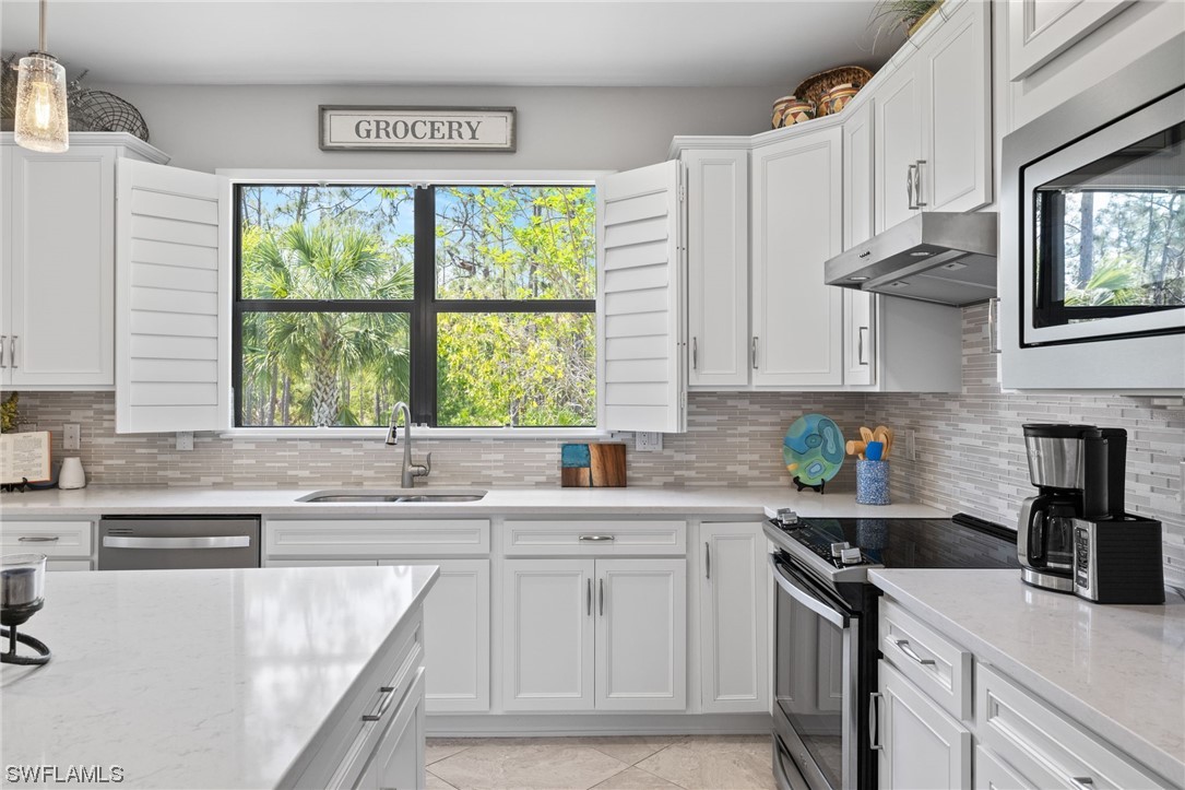 11237 Carlingford Road Fort Myers, FL 33913 - Photo 2 of 38 a kitchen with stainless steel appliances granite countertop a sink a stove and cabinets