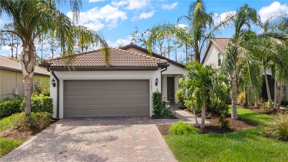 11237 Carlingford Road Fort Myers, FL 33913 - Photo 23 of 38 a front view of a house with a garden