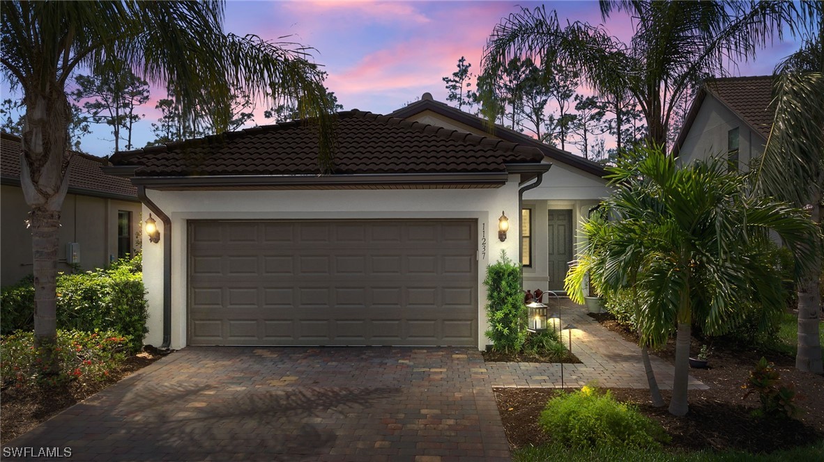 11237 Carlingford Road Fort Myers, FL 33913 - Photo 25 of 38 a front view of a house with a garden