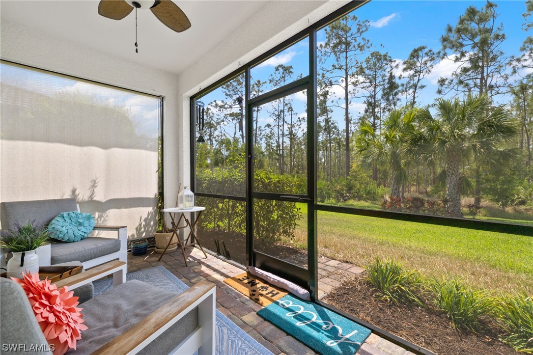 11237 Carlingford Road Fort Myers, FL 33913 - Photo 26 of 38 a living room filled with furniture and a floor to ceiling window