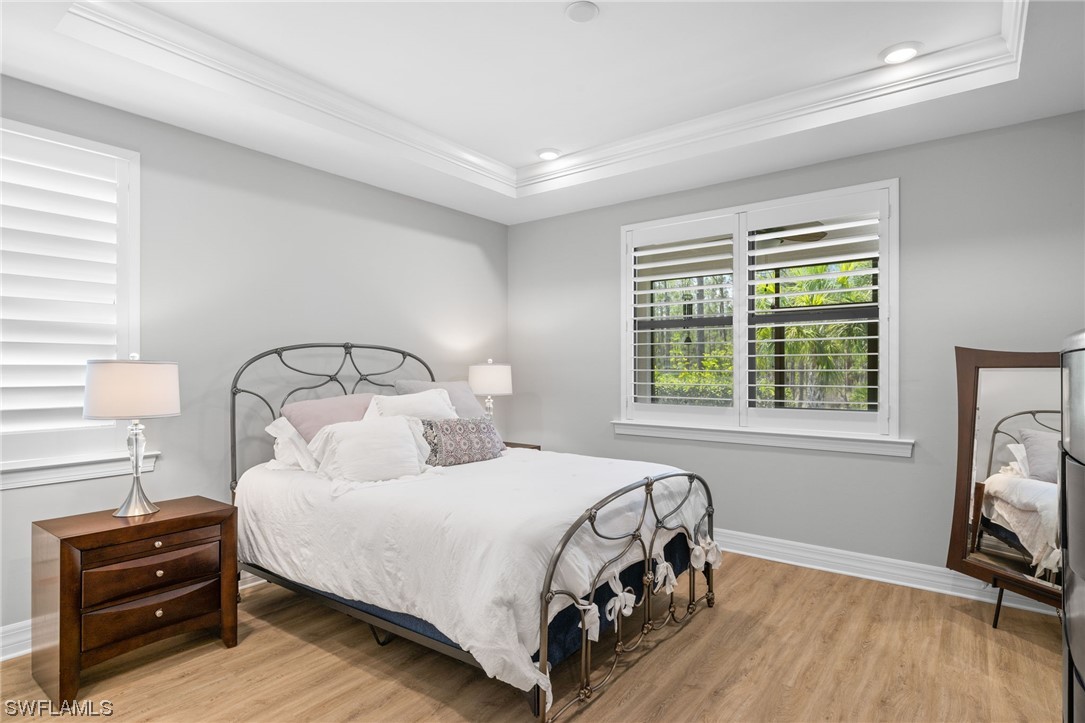 11237 Carlingford Road Fort Myers, FL 33913 - Photo 6 of 38 a bedroom with a bed and a mirror on the dresser