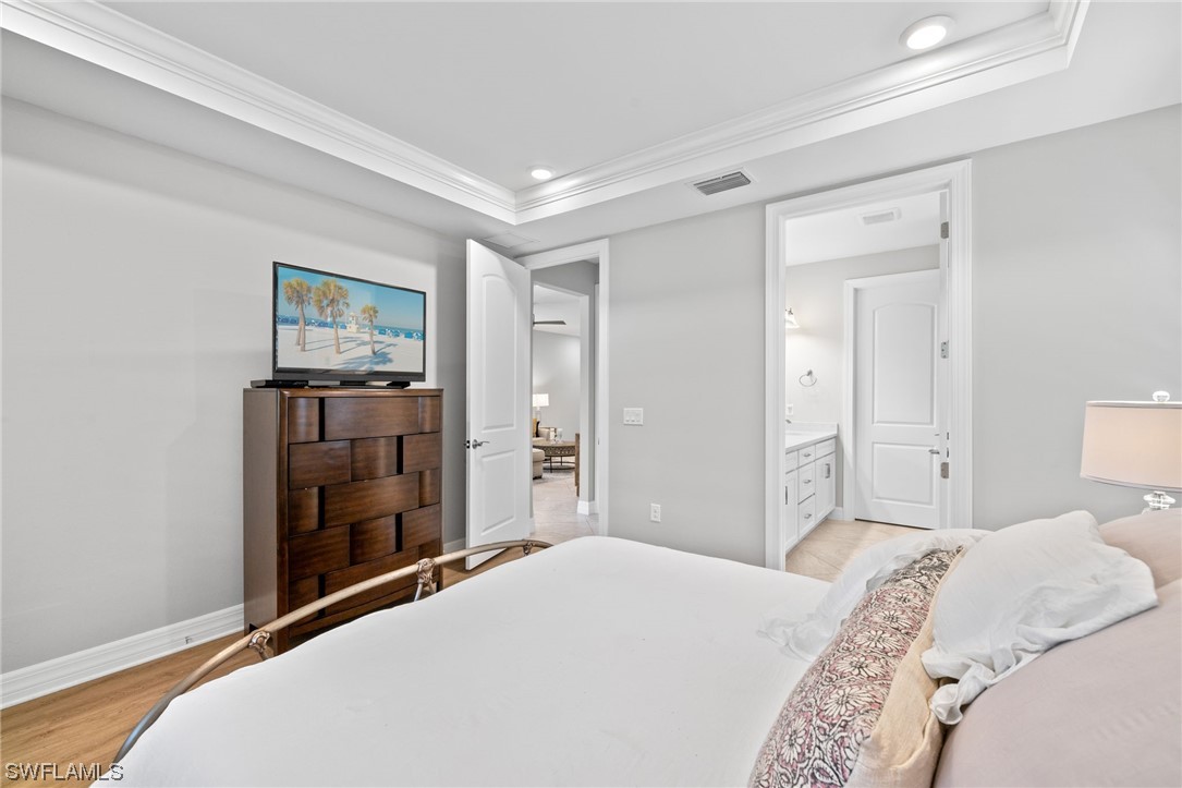 11237 Carlingford Road Fort Myers, FL 33913 - Photo 7 of 38 a bedroom with a bed and a flat tv screen