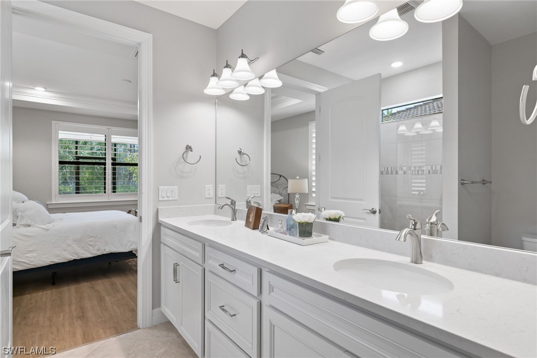 11237 Carlingford Road Fort Myers, FL 33913 - Photo 8 of 38 a spacious bathroom with double vanity a mirror and a bathtub