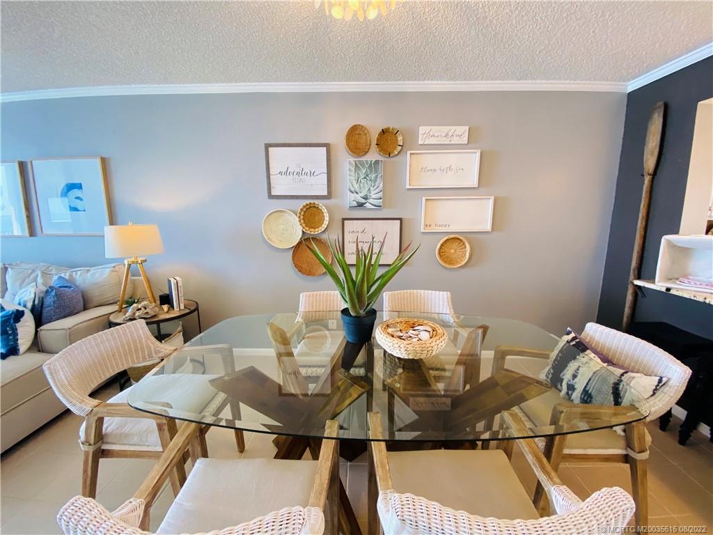 7380 South Ocean Drive, Unit 718A Jensen Beach, FL 34957 - Photo 12 of 58 a view of a dining room with furniture and wooden floor