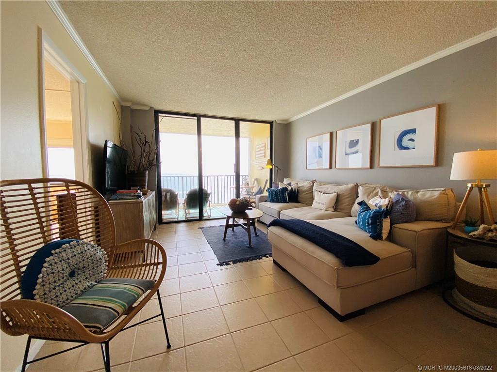 7380 South Ocean Drive, Unit 718A Jensen Beach, FL 34957 - Photo 13 of 58 a living room with furniture and a flat screen tv